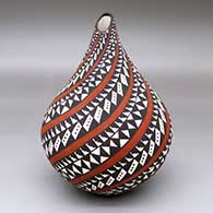 A polychrome tear-drop jar with an organic opening and decorated with a spiraling geometric design
 by Sandra Victorino of Acoma