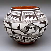 A polychrome jar decorated with a black-and-white fine line, spinning logs and geometric design
 by Virginia Lowden of Acoma