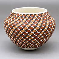 A polychrome pot decorated with a 3D geometric design
 by Frederica Antonio of Acoma