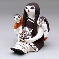 A sitting grandmother storyteller with two children, a pot, bird, butterfly and lady bug
 by Judy Lewis of Acoma