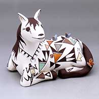 A polychrome sitting horse figure with birds, lady bugs, a lizard, a butterfly and decorated with a geometric design
 by Judy Lewis of Acoma