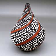 A polychrome tear drop jar decorated with a spiraling geometric design
 by Sandra Victorino of Acoma