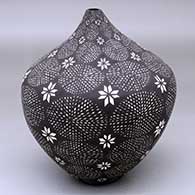 A black-on-white tear drop jar decorated with a flower and geometric design
 by Sandra Victorino of Acoma