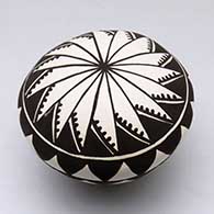 A black-on-white seed pot decorated with a geometric design
 by Cletus Victorino of Acoma