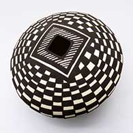 A black-on-white seed pot decorated with a checkerboard and geometric design
 by Cletus Victorino of Acoma