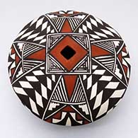 A polychrome seed pot decorated with an eight-panel geometric design and a square opening
 by Cletus Victorino of Acoma