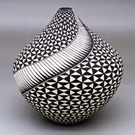 A black-on-white tear drop jar decorated with a geometric design
 by Cletus Victorino of Acoma