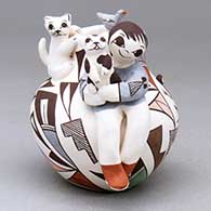 A polychrome Friendship jar with a boy, kittens, bird and painted with a geometric design
 by Judy Lewis of Acoma