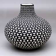 A black-on-white jar with a square rim and decorated with a geometric design
 by Paula Estevan of Acoma