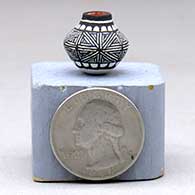 A miniature polychrome jar decorated with a black-on-white snowflake fine line and geometric design
 by LaDonna Victoriano of Acoma