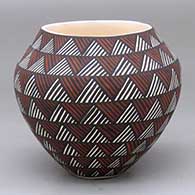 A polychrome jar decorated with bands of fine line rock art geometric design
 by Sandra Victorino of Acoma