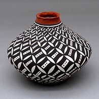 A polychrome jar with a pie crust rim and decorated with a pumpkin seed snowflake and geometric design
 by Sandra Victorino of Acoma