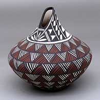 A polychrome tear drop jar with an organic opening and decorated with a fine line rock art and geometric design
 by Sandra Victorino of Acoma