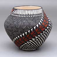 A polychrome jar decorated with a feather, checkerboard, fine line and spiraling geometric design
 by Sandra Victorino of Acoma