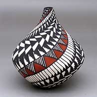 A polychrome tear drop jar decorated with a spiral ing feather, fine line and geometric design
 by Sandra Victorino of Acoma