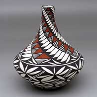 A polychrome tear drop jar decorated with a pumpkin seed snowflake and spiral feather, fine line and geometric design
 by Sandra Victorino of Acoma