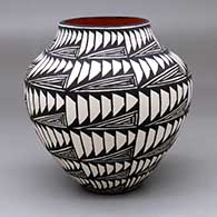 A polychrome jar decorated with bands of geometric design
 by Sandra Victorino of Acoma