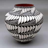 A polychrome jar decorated with bands of geometric design
 by Sandra Victorino of Acoma