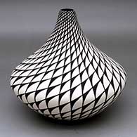 A black-on-white jar decorated with a spiral mesa geometric design
 by Sandra Victorino of Acoma