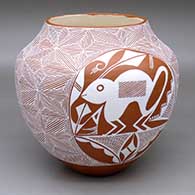 A white on red jar decorated with medallions with a rabbit and a bear, plus snowflake fine line geometric design around and in between
 by Adrian Trujillo of Acoma