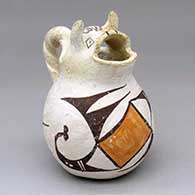 A polychrome cream pitcher with a cow head spout, twisted handle and geometric design
 by Unknown of Acoma