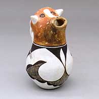 A polychrome cow head cream pitcher with a twisted handle and a geometric design
 by Unknown of Acoma