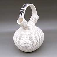 A corrugated white wedding vase with a black-on-white geometric design on the bridge
 by Jackie Shutiva of Acoma