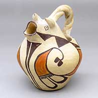 A polychrome cream pitcher with a cow head spout, twisted handle and geometric design around the body
 by Unknown of Acoma