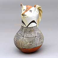 A polychrome cream pitcher with a cow head spout, twisted handle and a black-on-white geometric design around the body
 by Unknown of Acoma