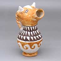 A polychrome cream pitcher with a cow head spout, twisted handle and geometric design
 by Mabel Brown of Acoma