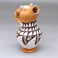 A polychrome cream pitcher with a cow head spout, twisted handle and black-on-white geometric design
 by Mabel Brown of Acoma