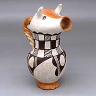 A polychrome cream pitcher with a cow head spout, twisted handle and black-on-white checkerboard and geometric design around the body
 by Mabel Brown of Acoma