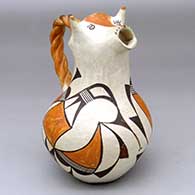 A polychrome cream pitcher with a cow head spout, twisted handle and a geometric design around the body and neck
 by Unknown of Acoma