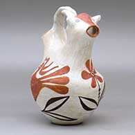 A polychrome wedding vase with a twisted bridge, a cow head on one spout and decorated around the body with a parrot, flower and vine design, click or tap to see a larger version