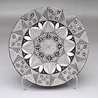 A polychrome plate decorated with a fine line and geometric design
 by Alisha Sanchez of Acoma