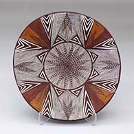 A polychrome plate with a fine line and geometric design
 by Carolyn Concho of Acoma