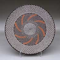 A large polychrome plate decorated with a North Star fine line, pumpkin seed snowflake and geometric design
 by Amanda Lucario of Acoma