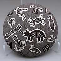 A black-on-white seed pot decorated above the shoulder with a fine line, Mimbres creature and geometric design
 by Rebecca Lucario of Acoma