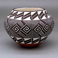 A polychrome jar decorated with a black-on-white fine line and geometric design
 by Rebecca Lucario of Acoma