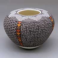 A polychrome jar decorated with a fine line and geometric design around the opening and with a painted checkerboard-based graphic design below
 by Frederica Antonio of Acoma