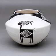 A black-on-white bowl decorated with a two-panel classic Mimbres animal, fish and geometric design
 by Emma Lewis of Acoma