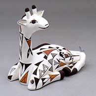 A polychrome giraffe figure decorated with a geometric design, plus a lizard, bird and lady bug
 by Judy Lewis of Acoma