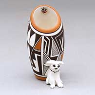 A polychrome jar with dog and lady bug appliques, and decorated with a geometric design
 by Judy Lewis of Acoma