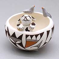 A polychrome bowl with a puppy inside and two bird appliques perched on the rim, the bowl decorated with a geometric design
 by Judy Lewis of Acoma