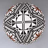 A polychrome seed pot decorated with a checkerboard, kiva step and geometric design
 by Cletus Victorino of Acoma