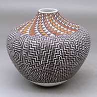 A high-shouldered polychrome jar decorated with a spiral mesa and fine line checkerboard geometric design
 by Frederica Antonio of Acoma