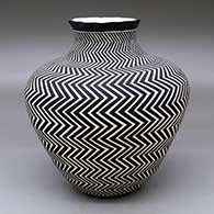 A black-on-white jar with a pie crust rim and decorated with a lightning bolt design from top to bottom
 by Paula Estevan of Acoma