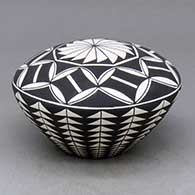 A black-on-white seed pot decorated with a geometric design
 by Cletus Victorino of Acoma