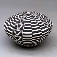 A black-on-white seed pot decorated with a checkerboard and geometric design
 by Cletus Victorino of Acoma