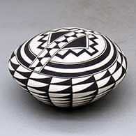 A black-on-white seed pot decorated with a spiral mesa, kiva step and geometric design
 by Cletus Victorino of Acoma